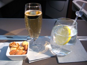 Glass of champagne, a gin and tonic and some nuts