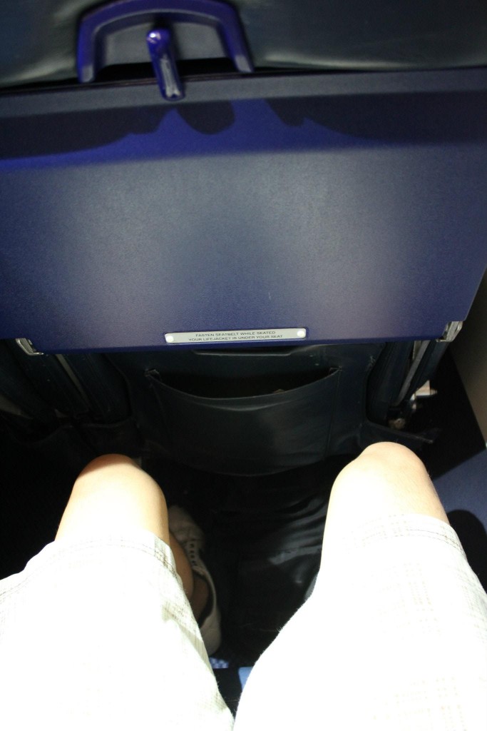 a person's legs and feet in a seat