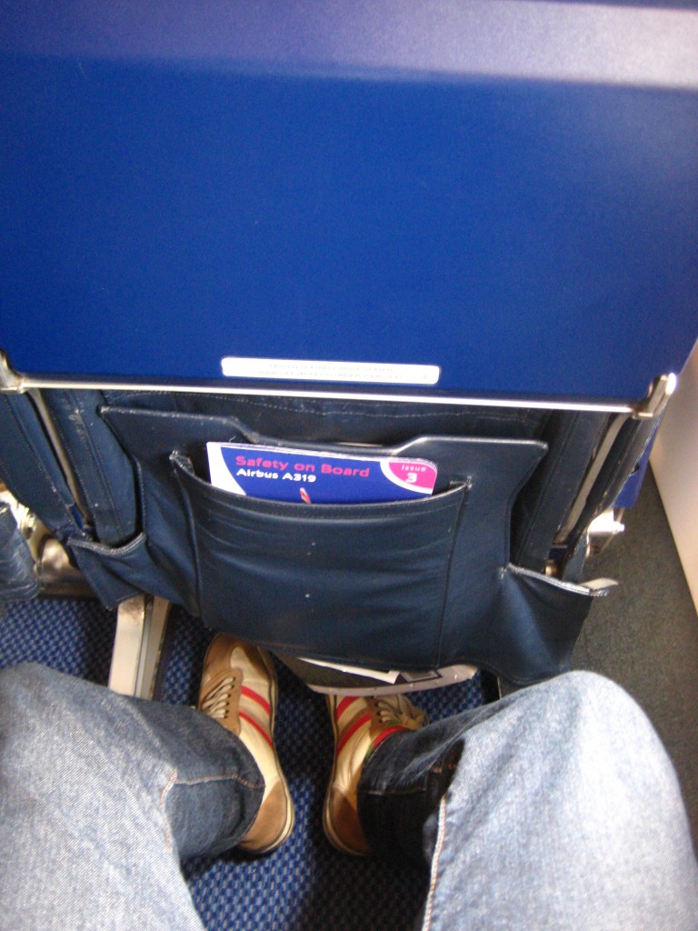 a person's legs in a pocket on an airplane