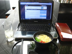 a laptop and a bowl of food