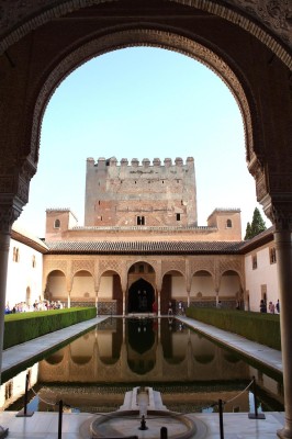 a pool in a courtyard with a castle in the background