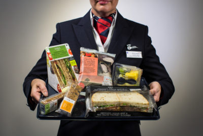 a person holding a tray of food