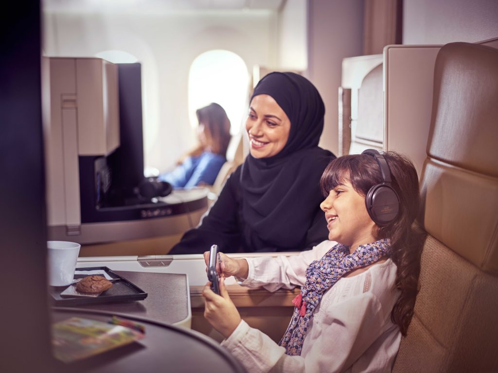 a woman and child sitting in an airplane