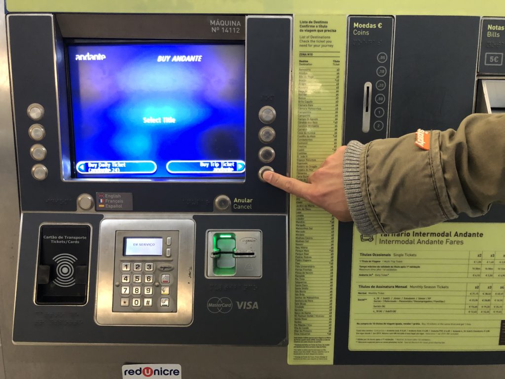 a hand pressing a button on a machine