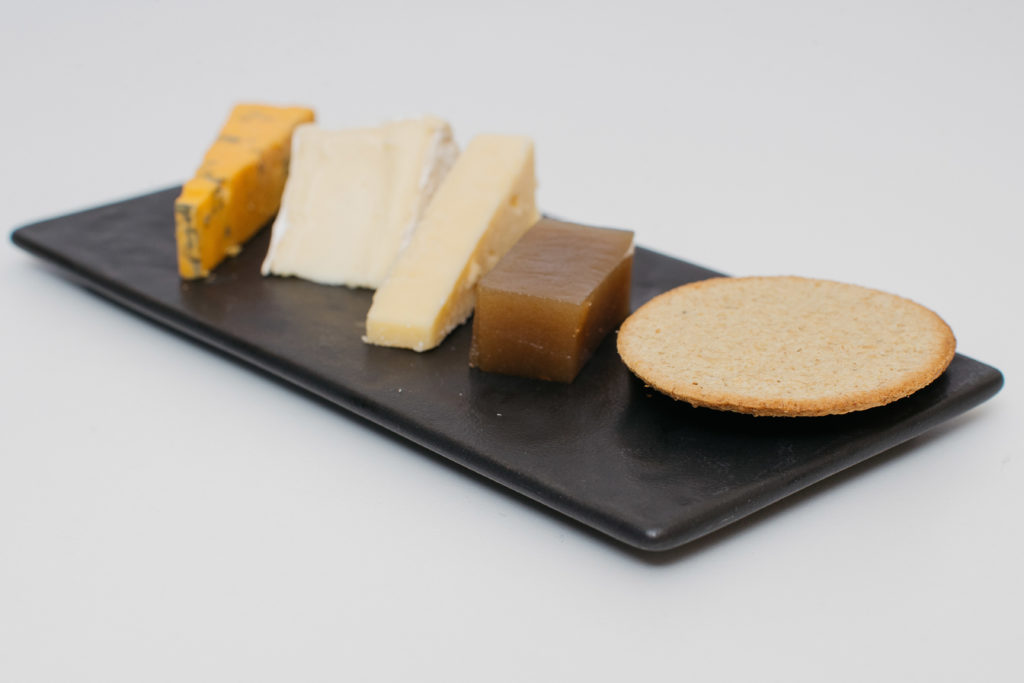 a plate of cheeses and crackers