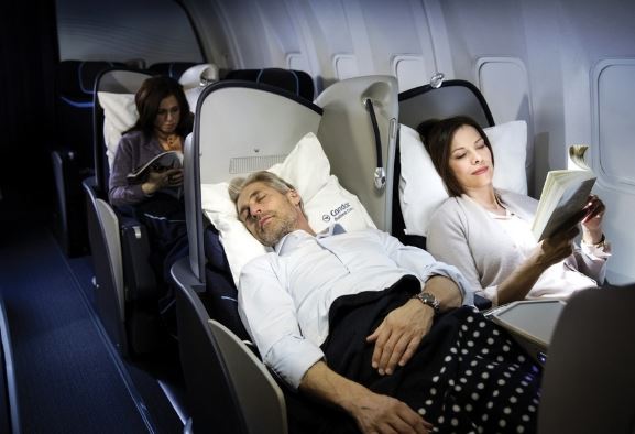 a group of people sleeping on an airplane