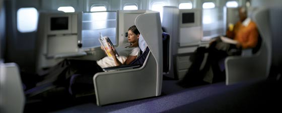 a woman reading a magazine in an airplane