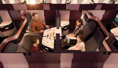 a family sitting at a table in a business class