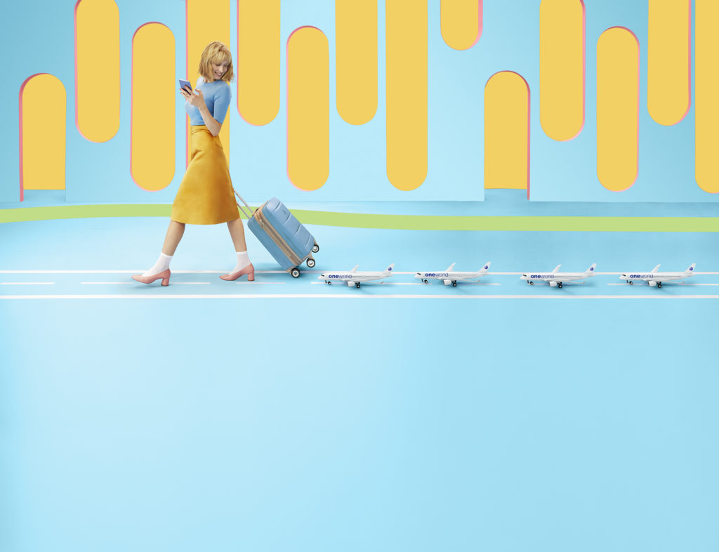 a woman walking with luggage and a phone