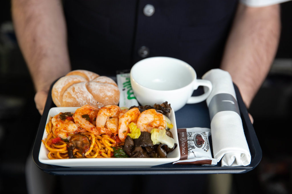 a tray of food and a cup of coffee