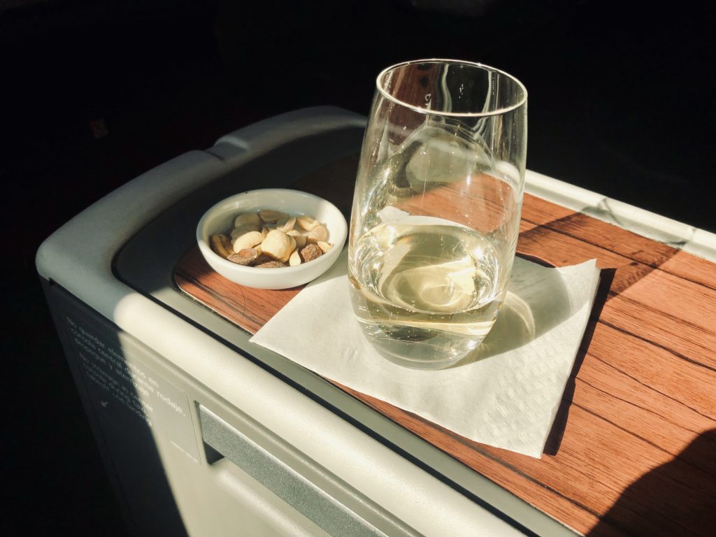 a glass of water and a bowl of food on a tray