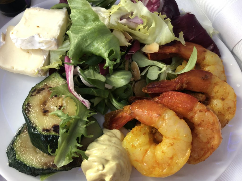 a plate of food with shrimp and salad