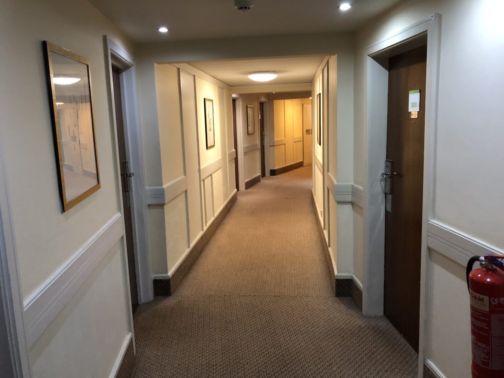 a hallway with a door and a door open