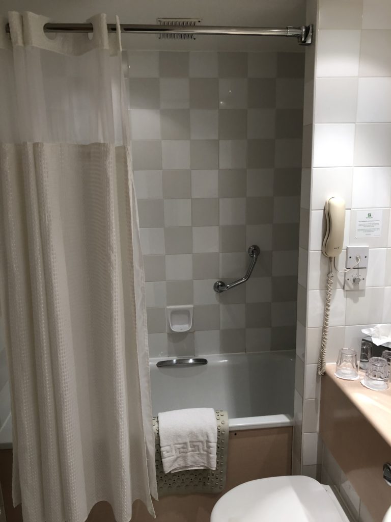 a bathroom with a bathtub and shower curtain