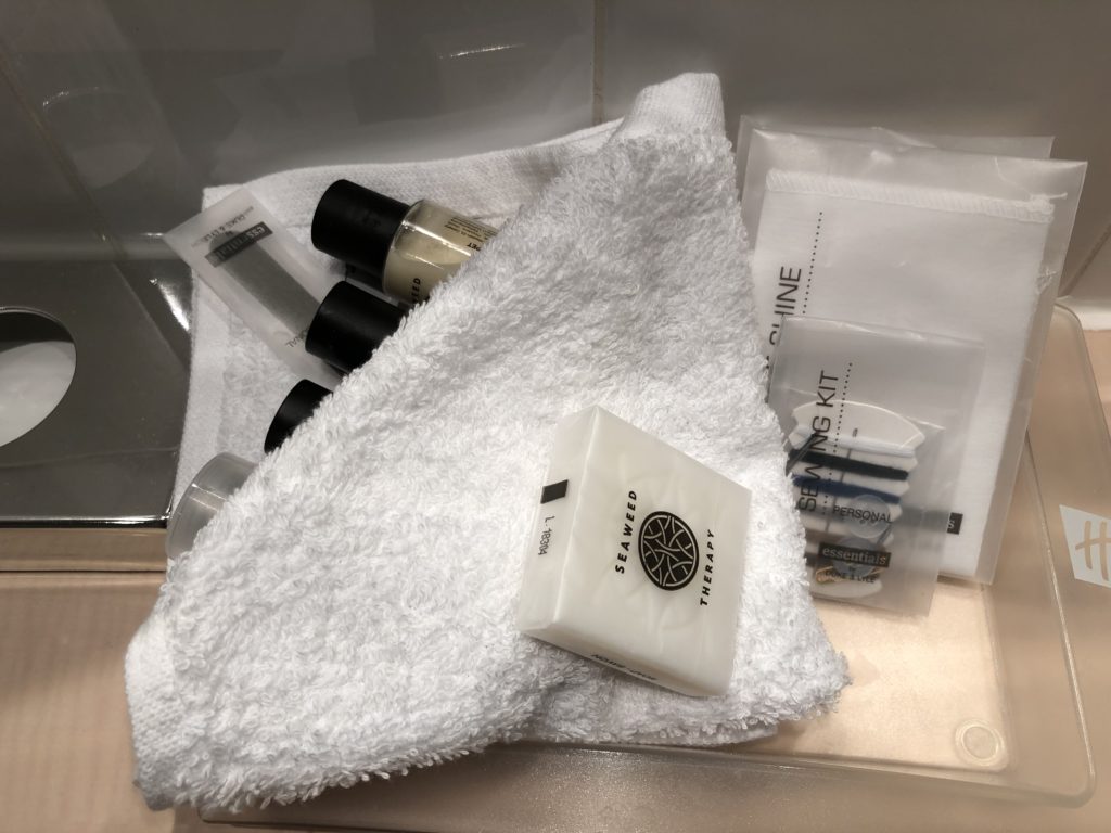 a towel with small bottles and small items on it