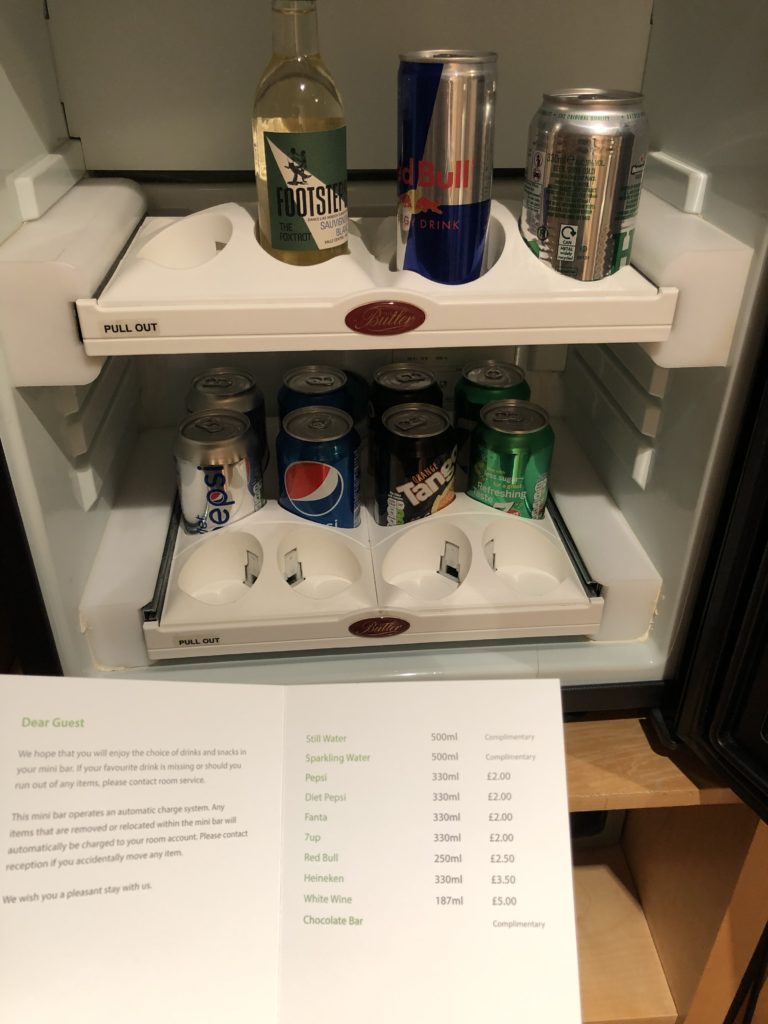 a refrigerator with cans of soda and cans of soda