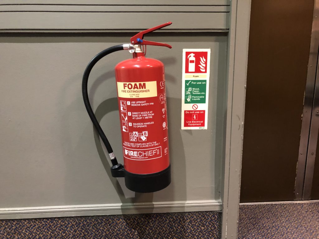 a fire extinguisher on a wall