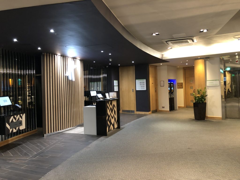 a lobby with a reception desk and a planter