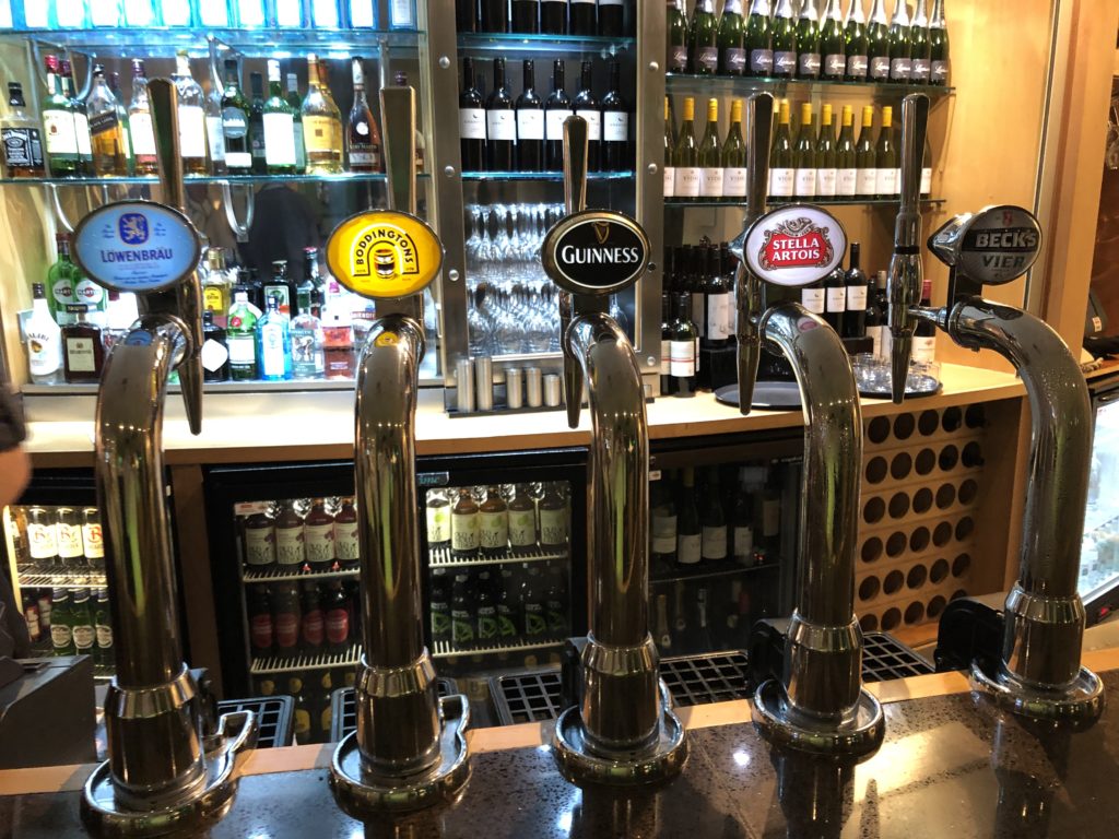 a row of beer taps in a bar