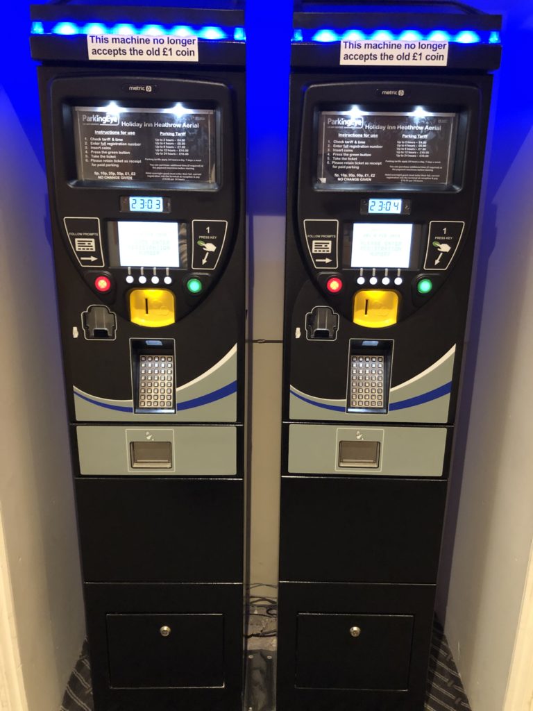 a two machines with buttons and a blue light