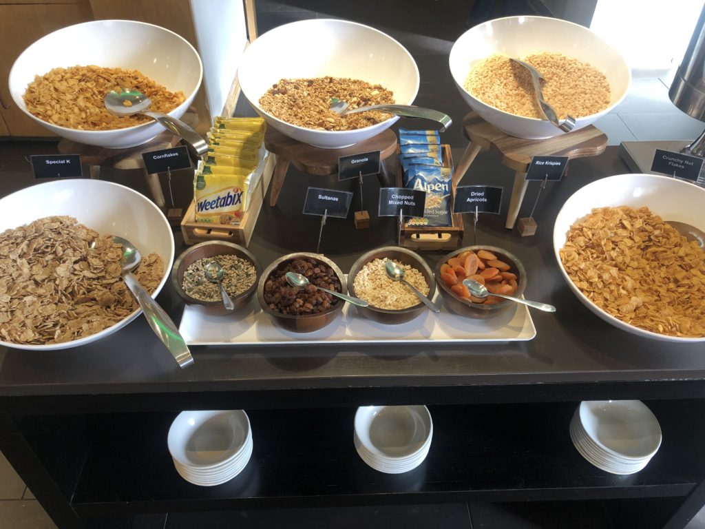 a table with bowls of cereal and cereals