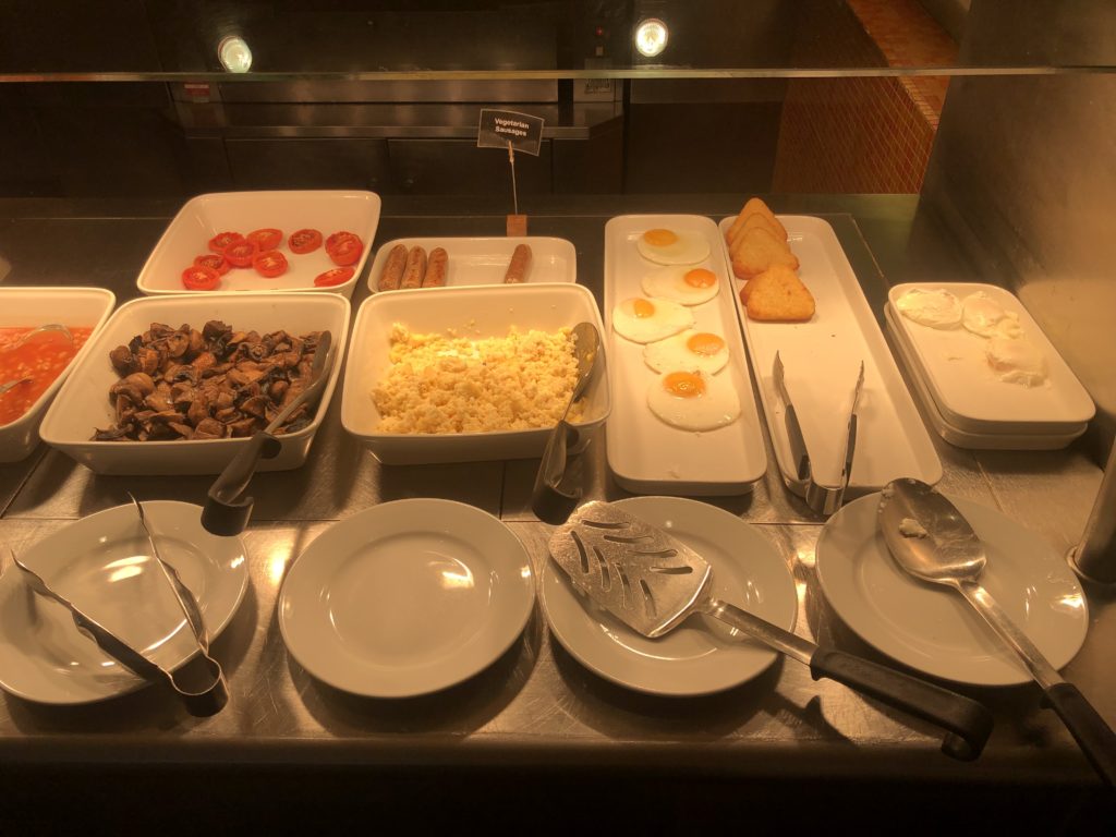 a buffet table with plates and bowls of food