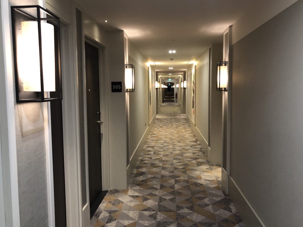 a hallway with lights and a tile floor