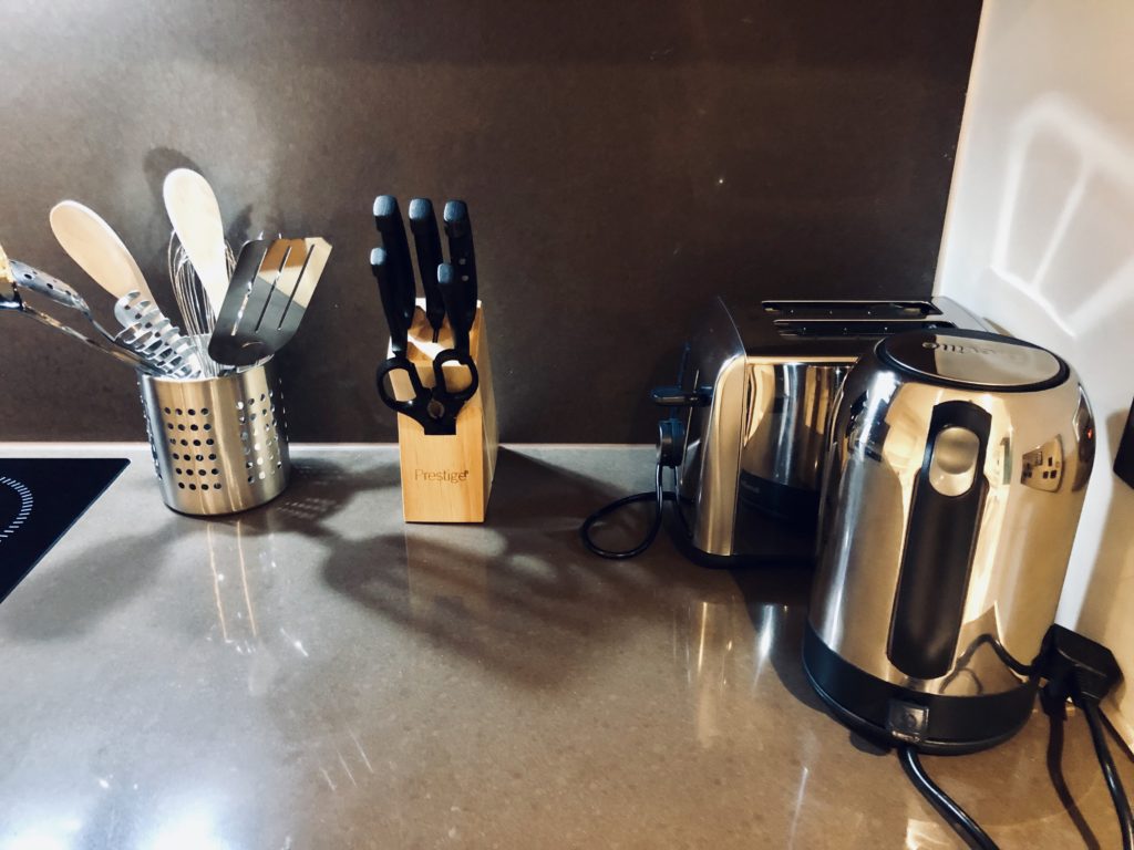 a kitchen counter with utensils and a toaster