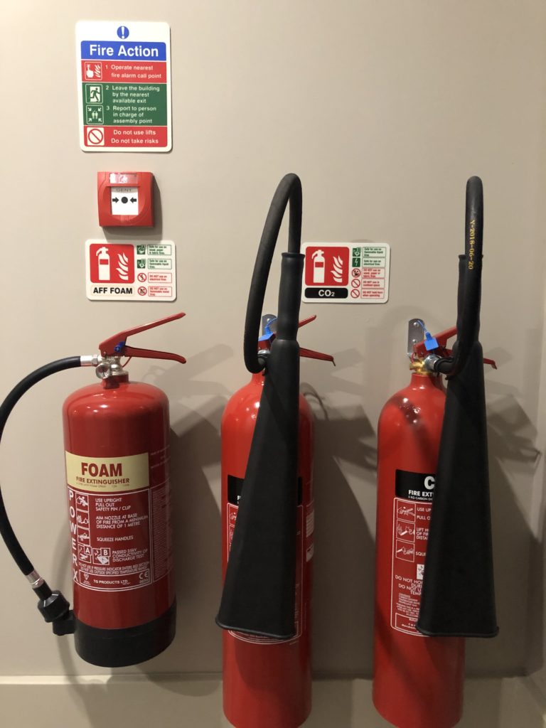 a group of fire extinguishers on a wall