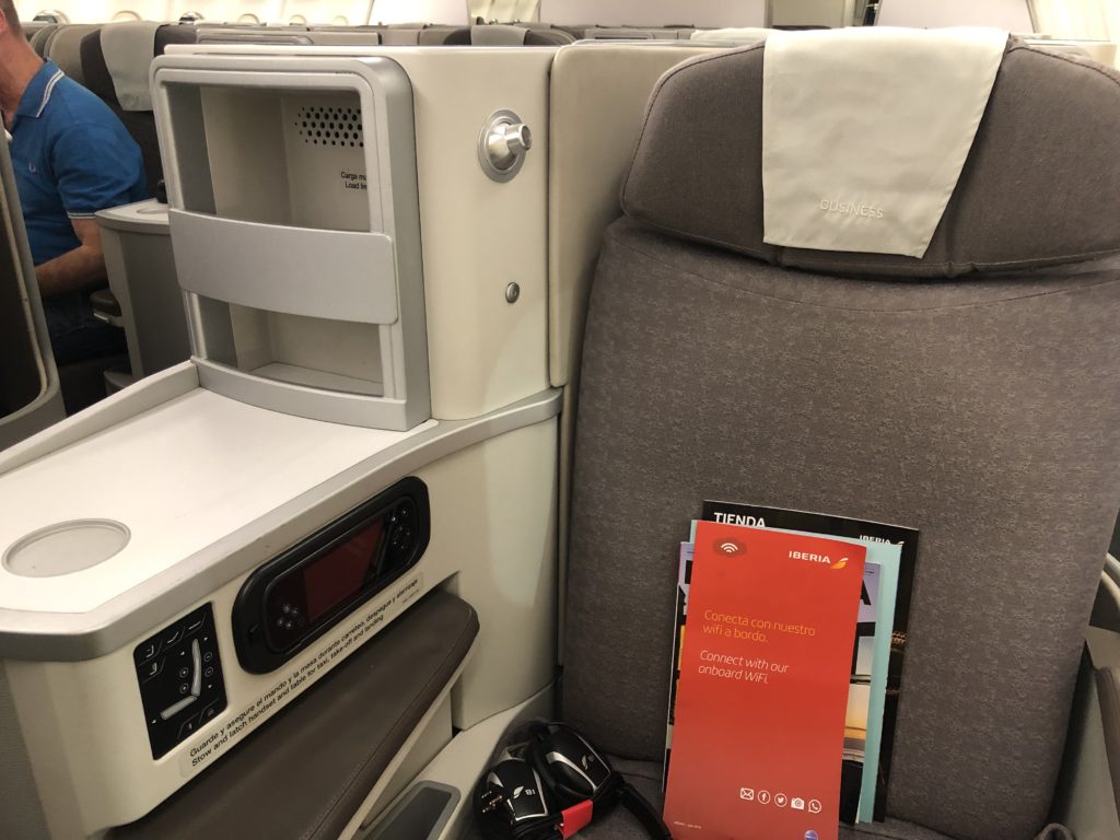 a seat with a book and a phone on it
