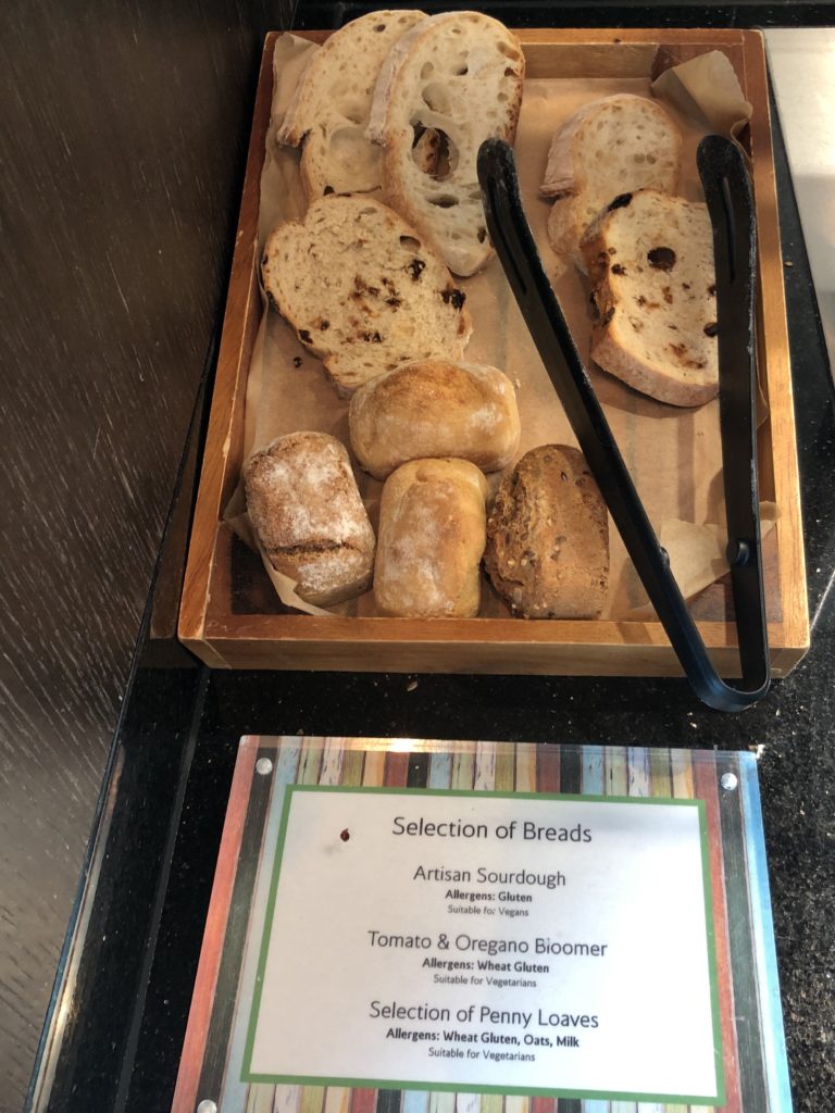 a tray of bread and a sign