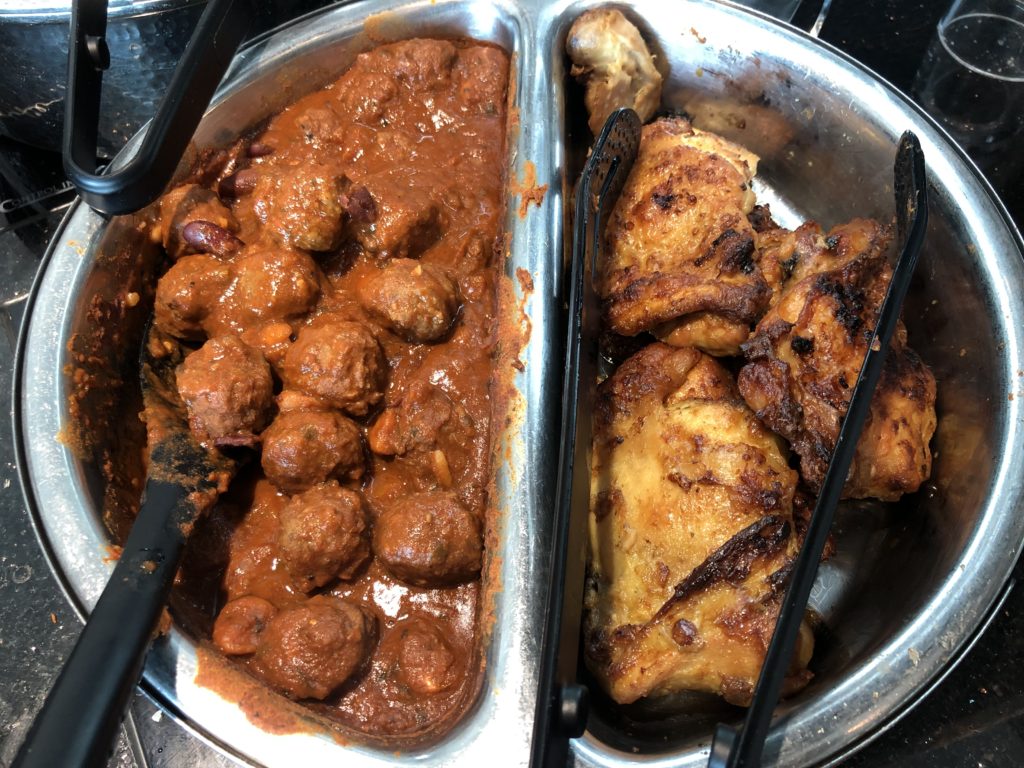 a tray of food with meat and sauce