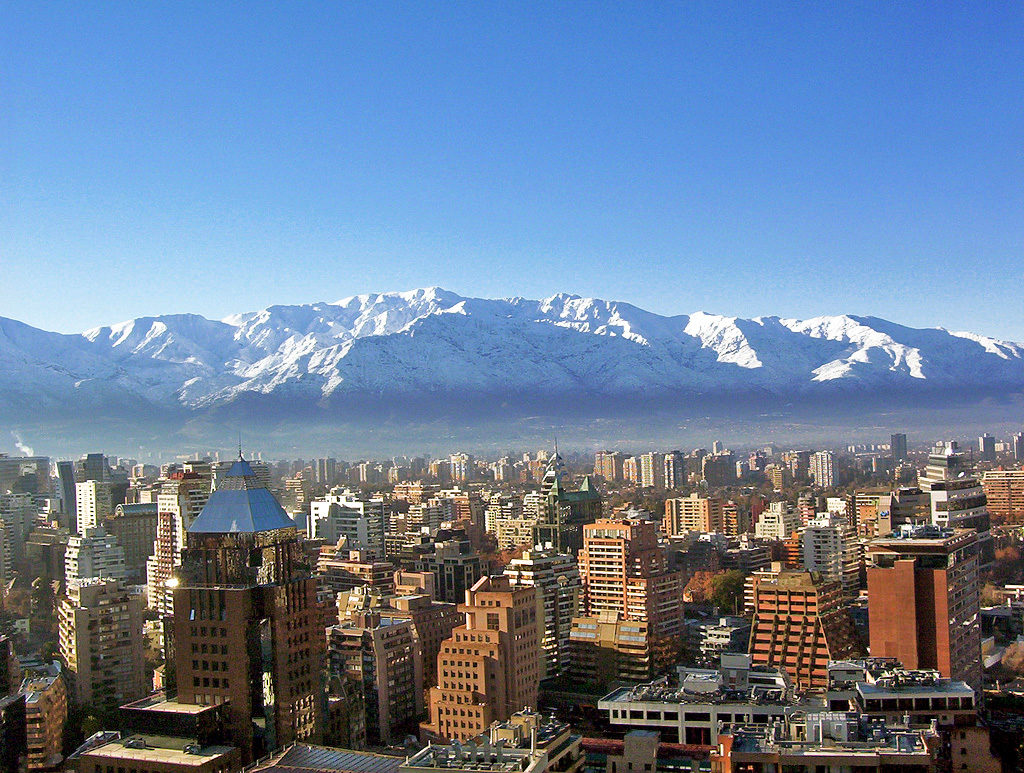 a city with snow covered mountains in the background