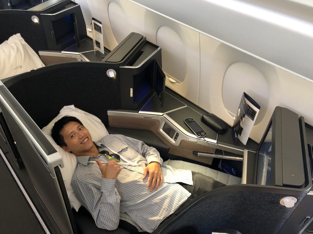 a man lying in a chair on an airplane