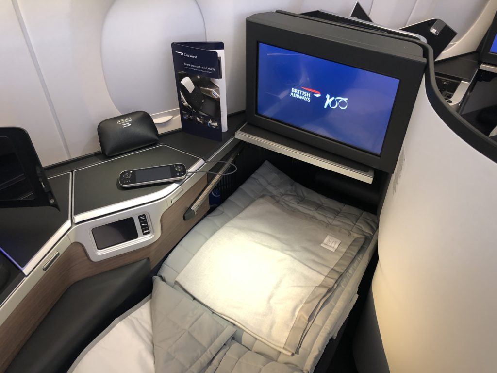 a bed with a tv and a bed in a plane