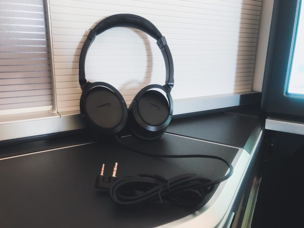 a pair of black headphones on a black surface