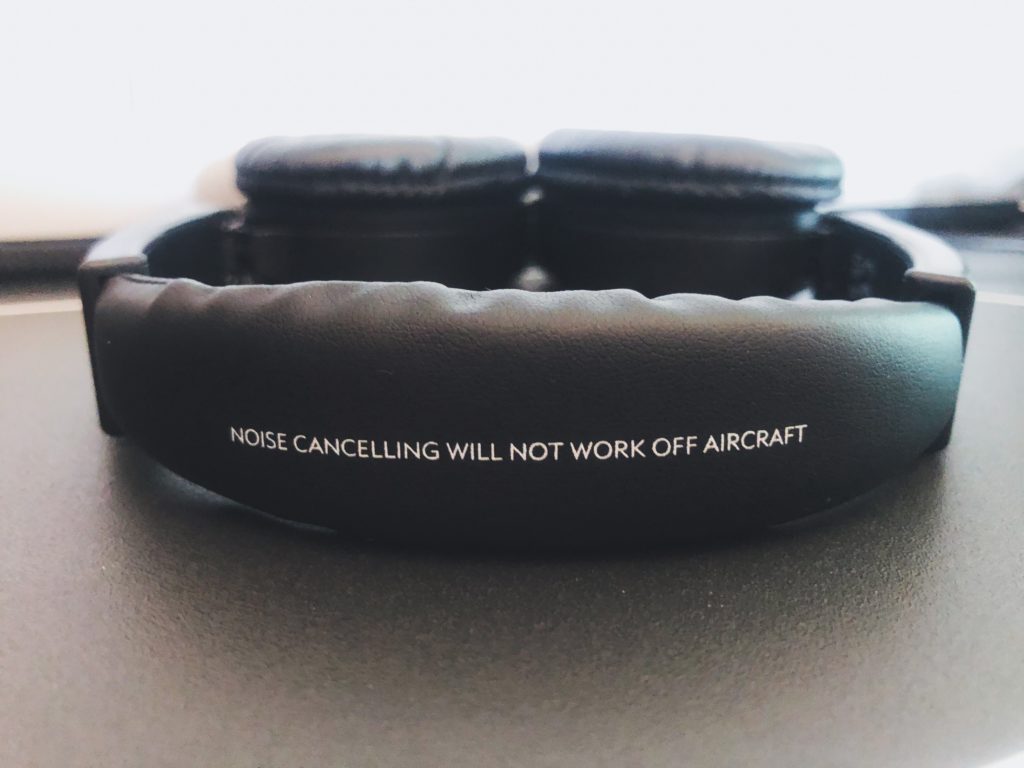 a pair of black headphones with white text