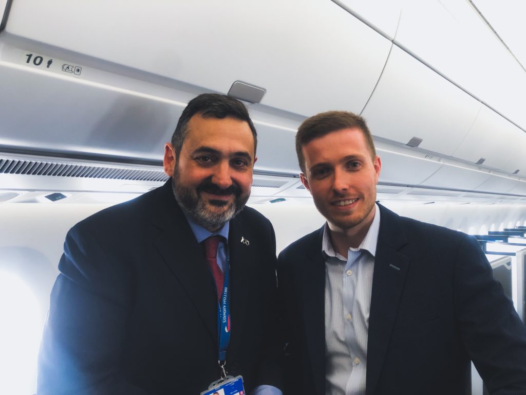 two men standing together in a plane