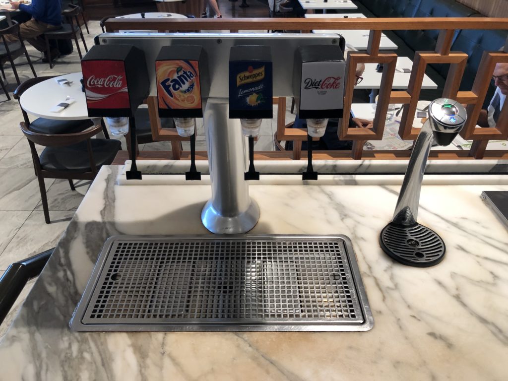 a soda dispenser on a marble table