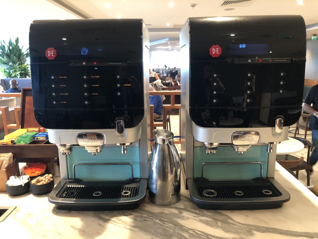 two coffee machines on a marble table