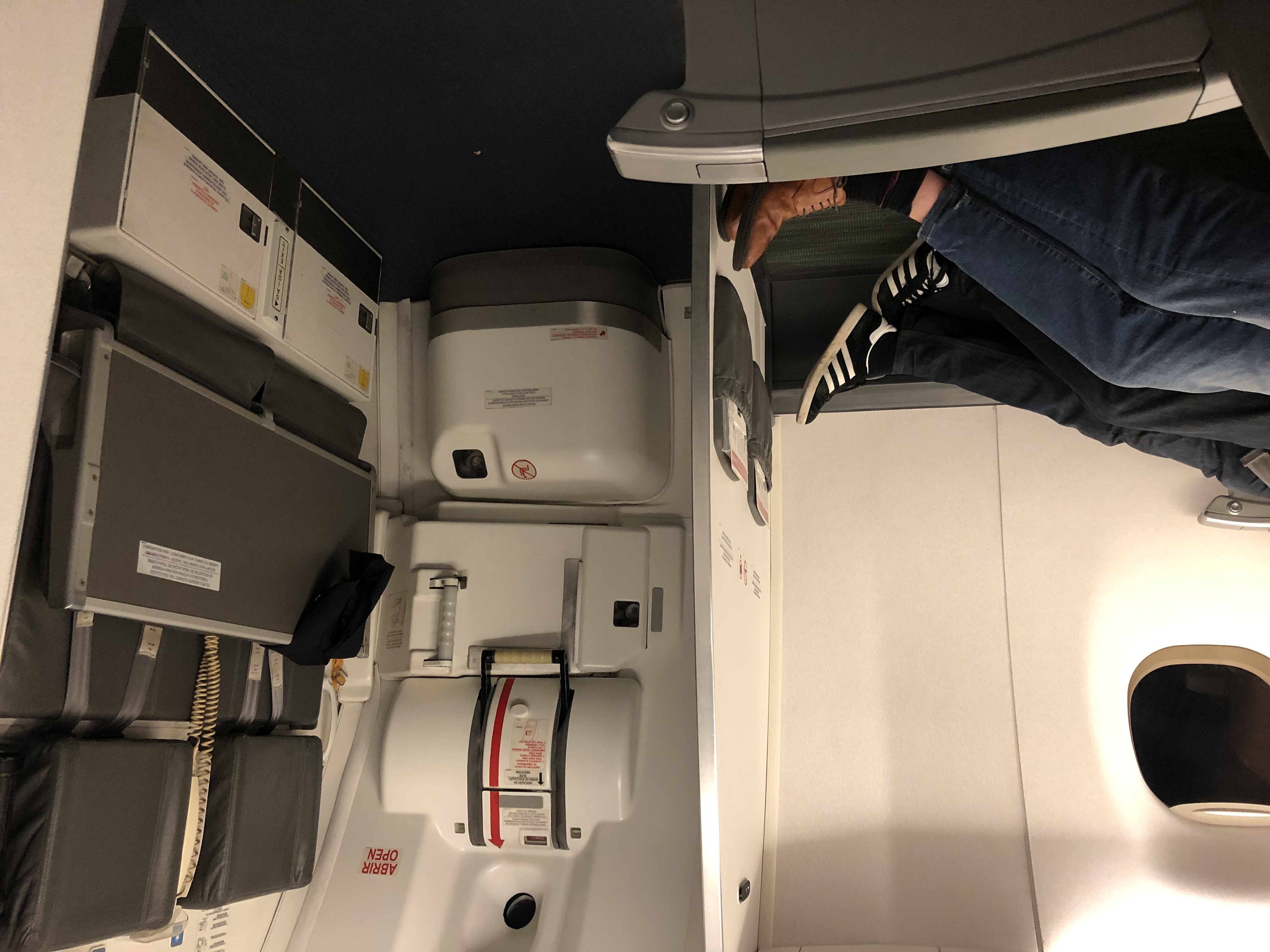 a person's legs in a seat on an airplane